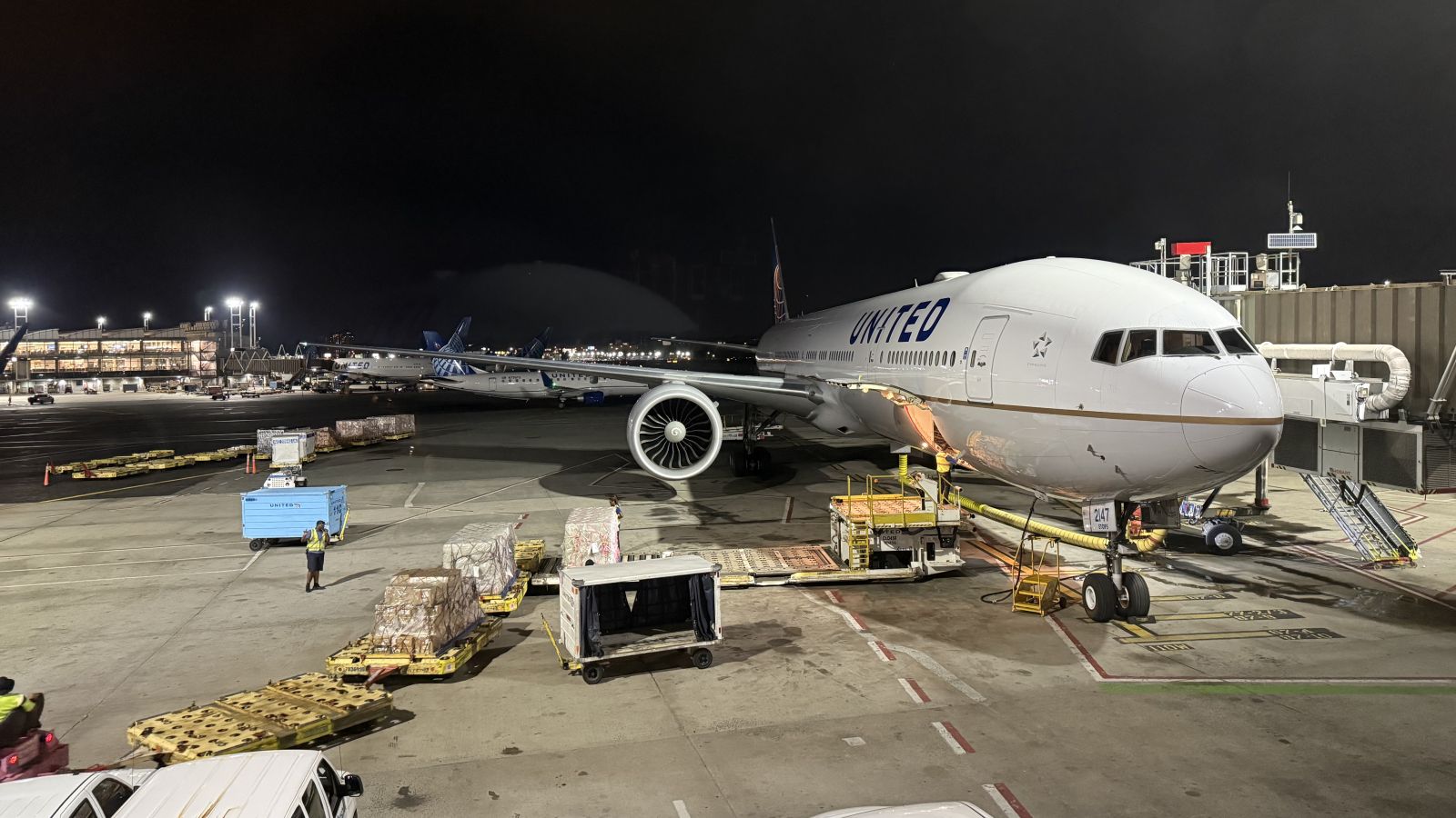United Airlines Boeing 777 at the gate at Terminal C of Newark Liberty International Airport at night