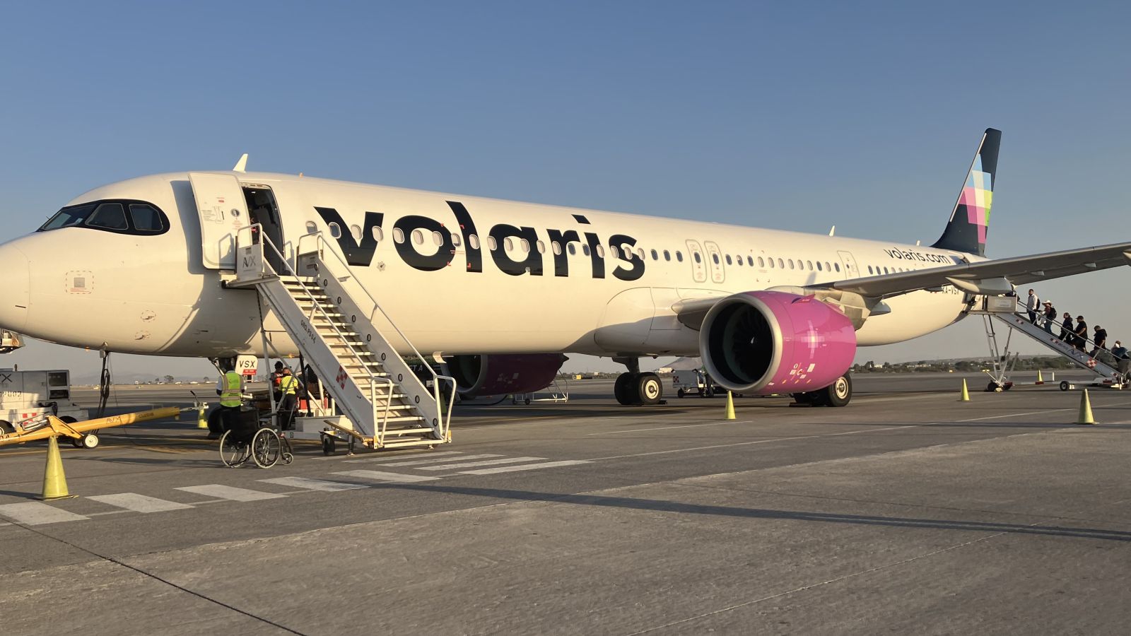 Passengers boarding a Volaris Airbus A321neo by stairs in Mexico
